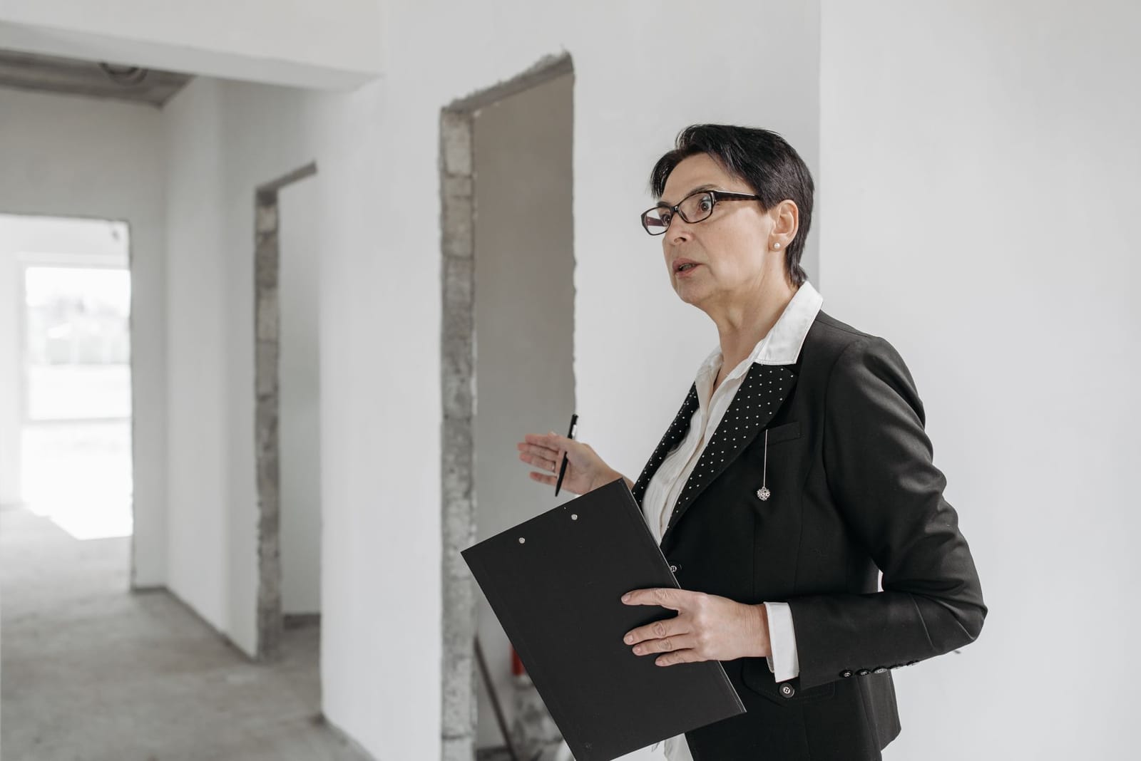An accredited energy assessor with a clipboard surveying a property for its EPC rating
